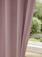 Luxury black blackout curtains from The Digital Kart hanging in a living room, blocking light and adding elegant decor.