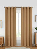 Luxury black blackout curtains in black fabric hanging in a stylish living room, blocking light effectively.