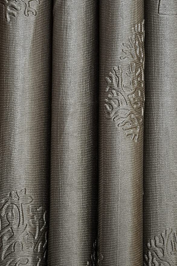 Grey Tree Punch Curtains by The Digital Kart hanging smoothly on a window, showcasing modern floral design and fabric texture.